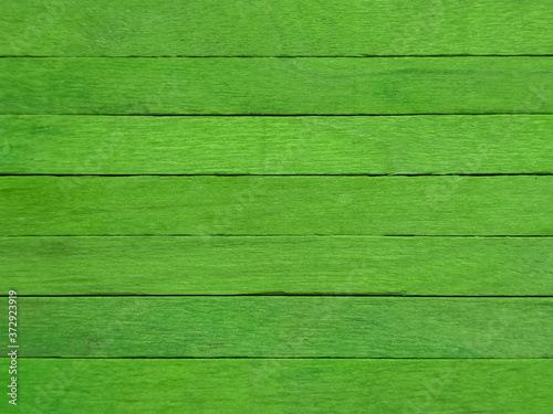 Background of green popsicle sticks with horizontal view.