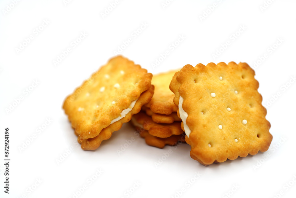 Stack of salted buttercream crackers on white background