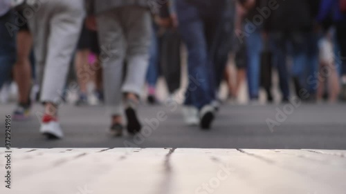 Closeup view of human feet people walking on crowded street in slow motion movement of life people variety pedestrian active walk city life urban many legs shoes traveling persons crowd