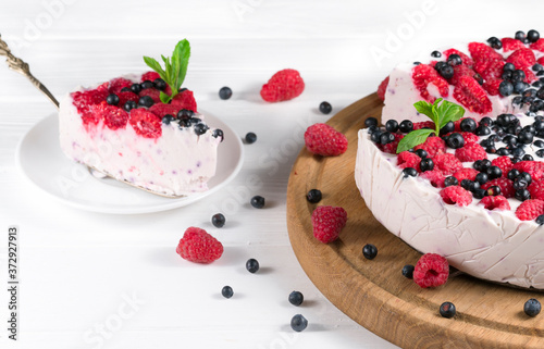 Beautiful white cream cheese cake with different summer berries