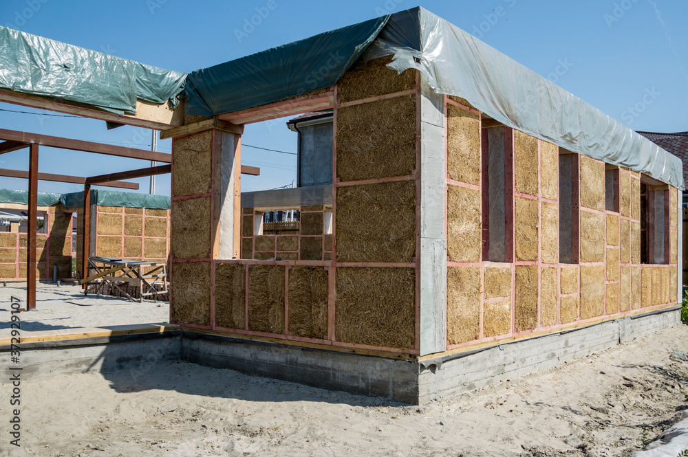 Construction of a house from an environmentally friendly material of plant origin. Frame made of wood, blocks of straw. Construction of a house from an environmentally friendly material of plant origin. Frame made of wood, blocks of straw.