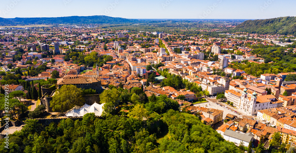Aerial view of Gorizia cityscape overlooking ancient fortress on top on hill in sunny autumn day, Italy