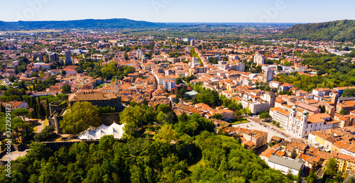 Aerial view of Gorizia cityscape overlooking ancient fortress on top on hill in sunny autumn day, Italy