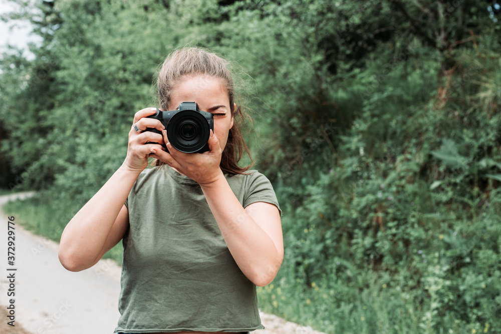 Cute, brunette girl taking photos with her camera. Outdoor photo, nature Cute, brunette girl taking photos with her camera. Outdoor photo, nature