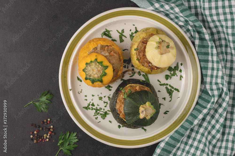 Vegetarian stuffed round zucchinis with vegetables, top view, flat lay. Ready to eat.