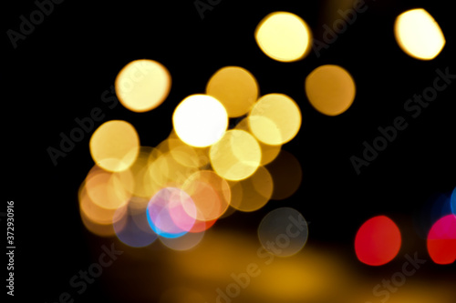 Bokeh light of street lamps at night with blurred background. © Sophon_Nawit