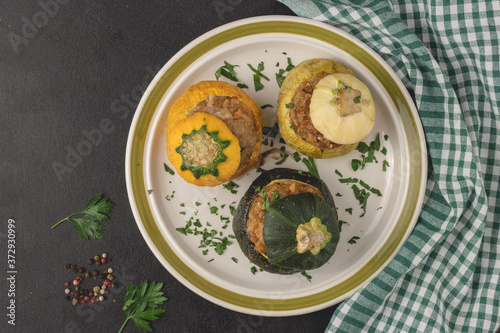 Vegetarian stuffed round zucchinis with vegetables, top view, flat lay. Ready to eat.