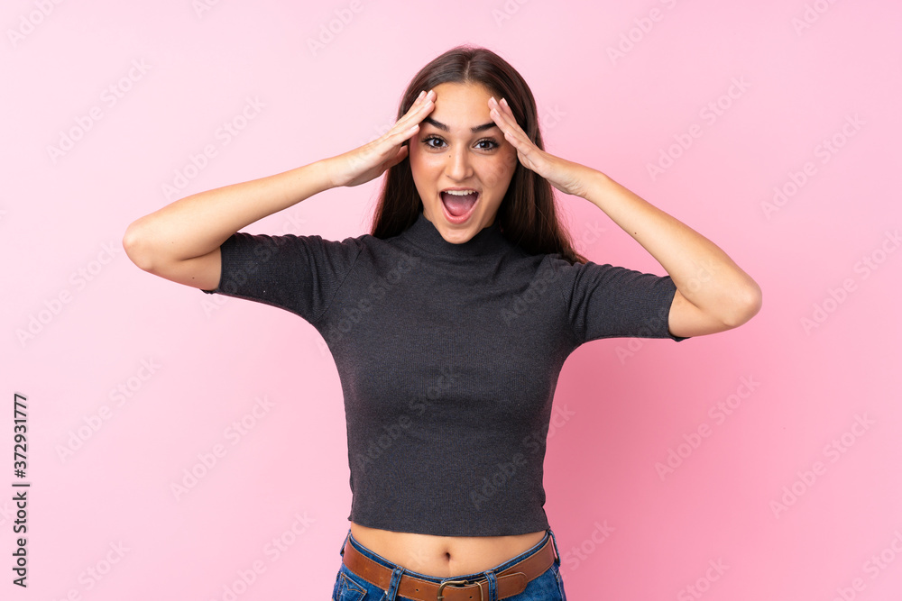 Young girl over isolated pink background with surprise expression Young girl over isolated pink background with surprise expression