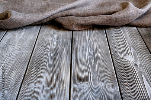 Rustic table made of planks. Canvas fabric. Background for design solutions.