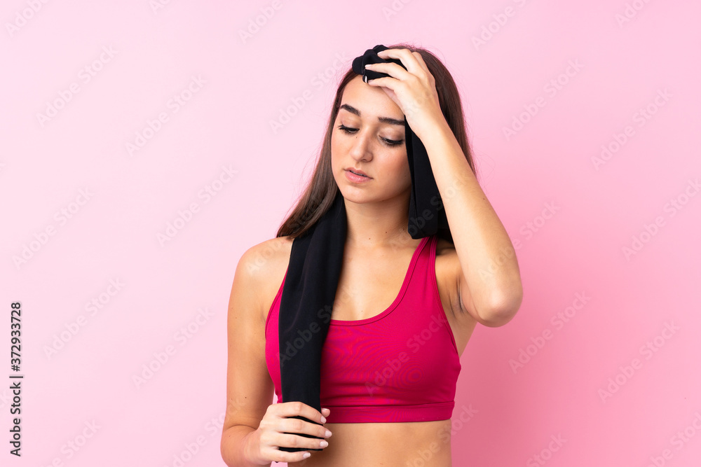 Young sport girl over isolated pink background with sport towel Young sport girl over isolated pink background with sport towel