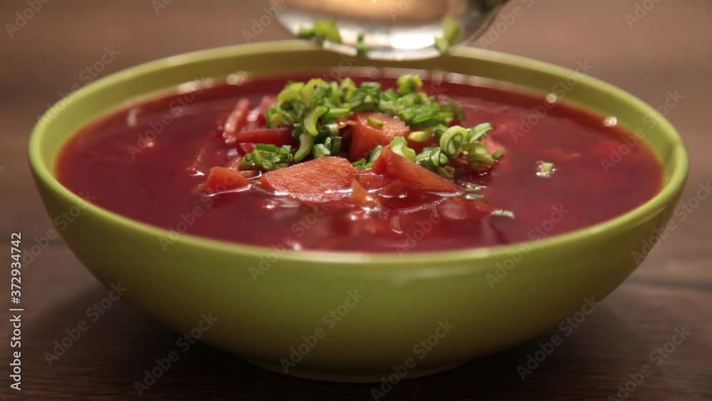 delicious red borscht in a green plate delicious red borscht in a green plate