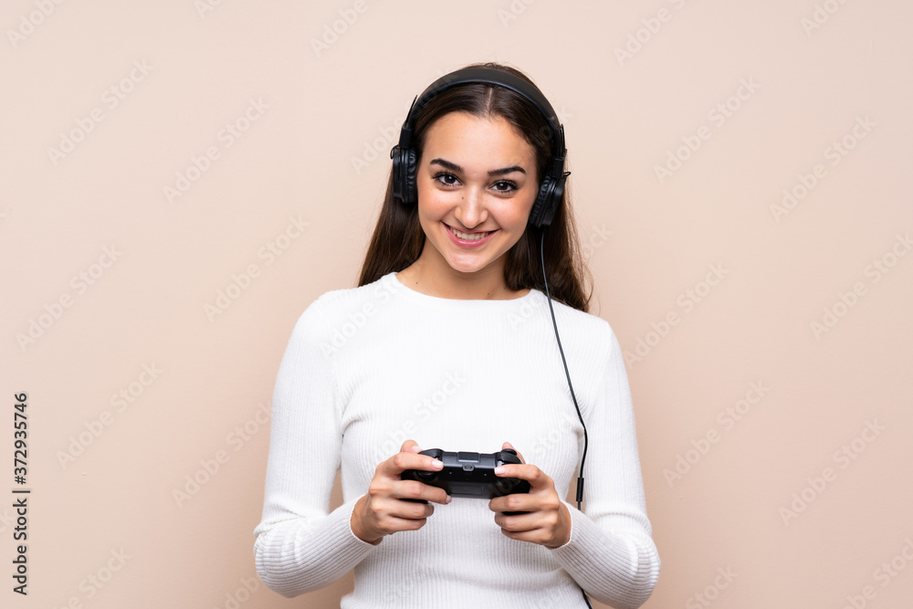 Young woman over isolated background playing at videogames Young woman over isolated background playing at videogames