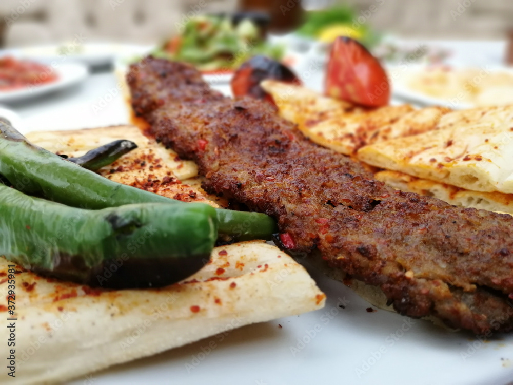 delicious Adana kebab and salads