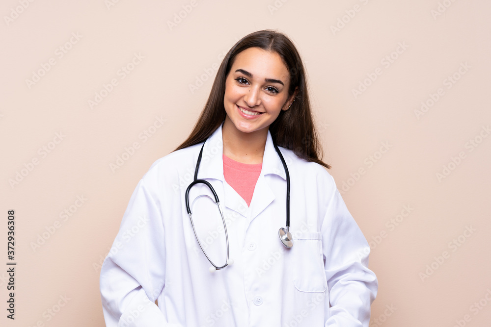 Young woman over isolated background with doctor gown Young woman over isolated background with doctor gown