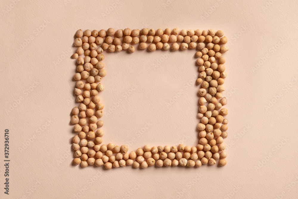 Square chickpeas seeds frame, border of chick pea beans, grain. Recipe background, copy space for text, top view. Food source of plant based vegan protein. Healthy vegetarian diet, veggie superfood. Square chickpeas seeds frame, border of chick pea beans, grain. Recipe background, copy space for text, top view. Food source of plant based vegan protein. Healthy vegetarian diet, veggie superfood.