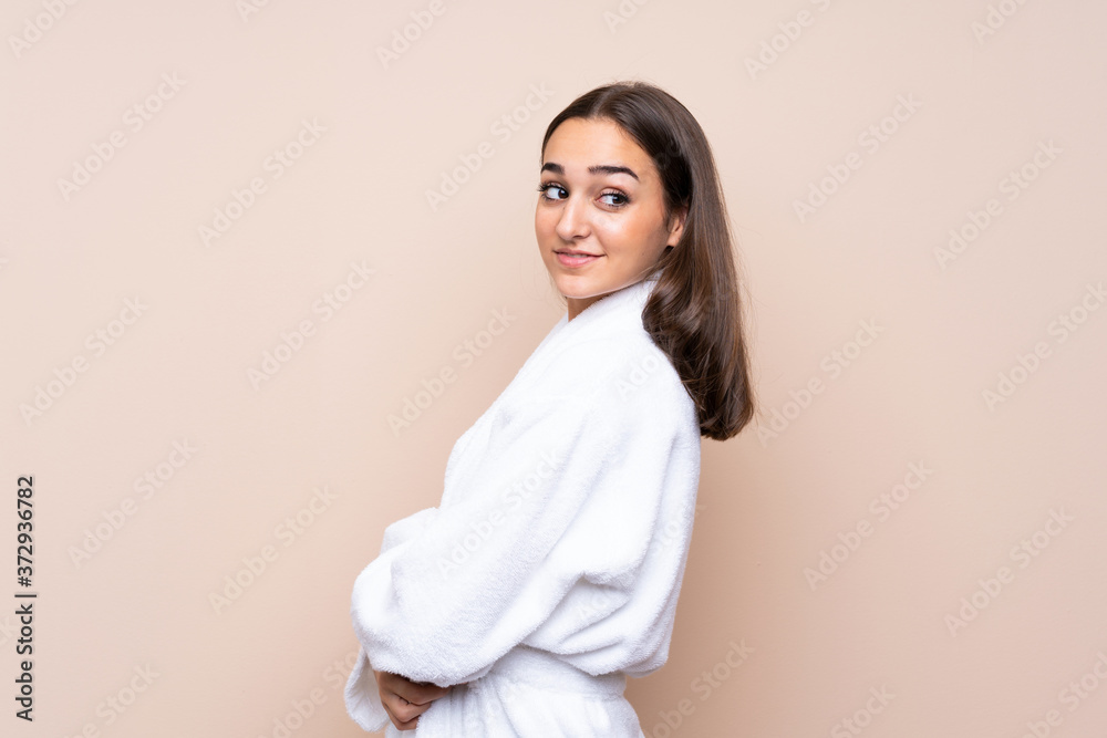 Young girl in a bathrobe over isolated background laughing Young girl in a bathrobe over isolated background laughing