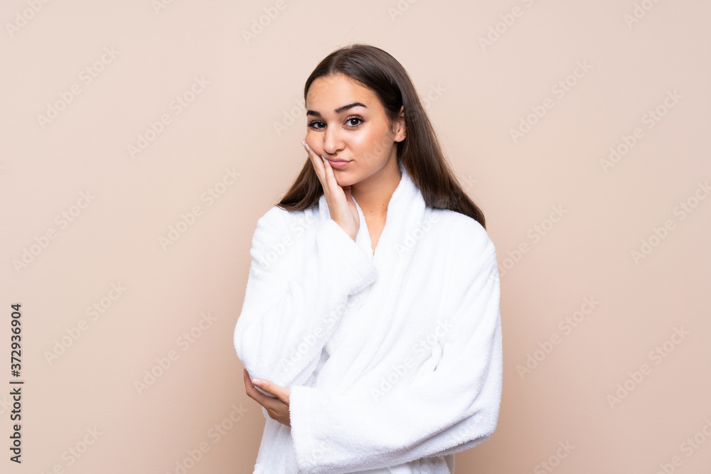 Young girl in a bathrobe over isolated background unhappy and frustrated Young girl in a bathrobe over isolated background unhappy and frustrated