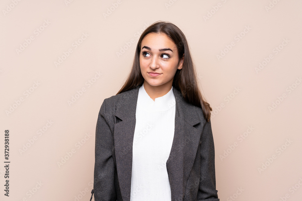 Young girl over isolated background standing and looking to the side Young girl over isolated background standing and looking to the side