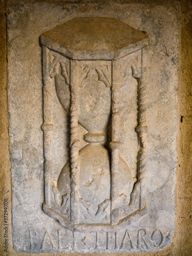 tepus fugit time flies a stone carved hourglass representing the passage of time photo
