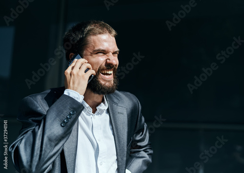 Business man communicates on the phone outdoors emotions executive manager lifestyle