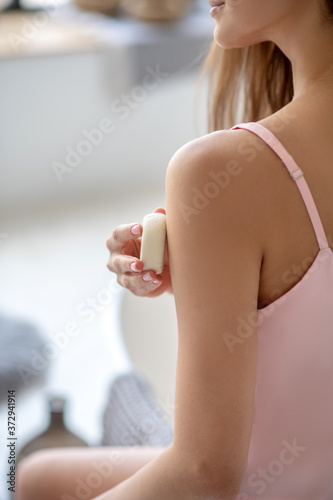 Close up picture of a woman holding bar of soap