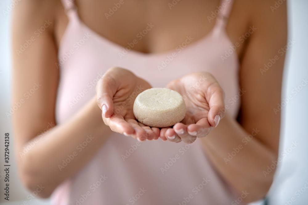 Close up picture of womans hands holding a bar of soap Close up picture of womans hands holding a bar of soap