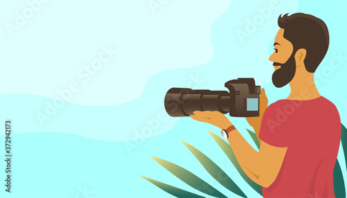 A young man with a beard takes pictures with a camera. Long telephoto lens. Stands among a tropical plant. Vector illustration banner with place for text.