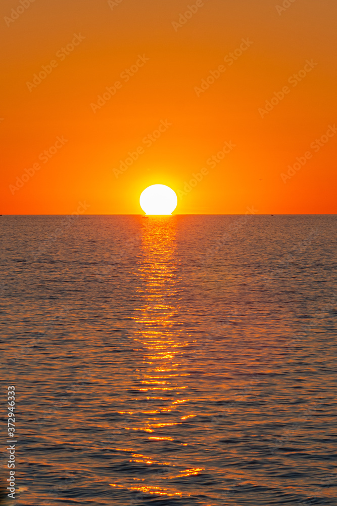 Orange sunset over calm water