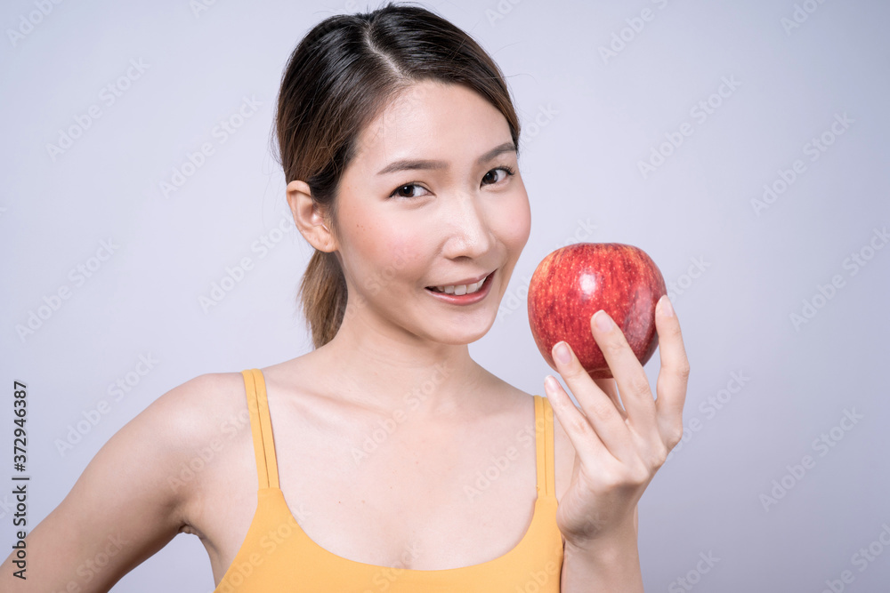 Asian woman holding apple in hand isolated on white background, Concept eating healthy food. Asian woman holding apple in hand isolated on white background, Concept eating healthy food.