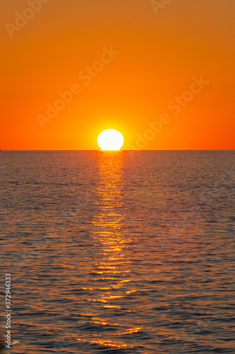 Orange sunset over calm water