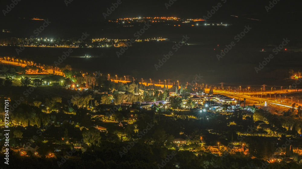 Aerail night view of Hula Valley with town of Rosh Pina and many agricultural settlements as seen from Mitzpe Hayamim hotel, located in Upper Galilee of Northern Israel, Israel.