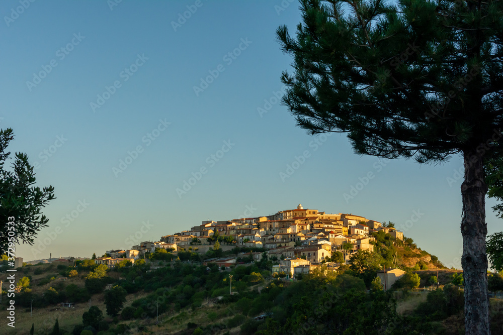 Panoramic View of the small village of Castroregio, in Basilicata, Italy. Summer Sunrise of scenic landscape of a small village in the South of Italy