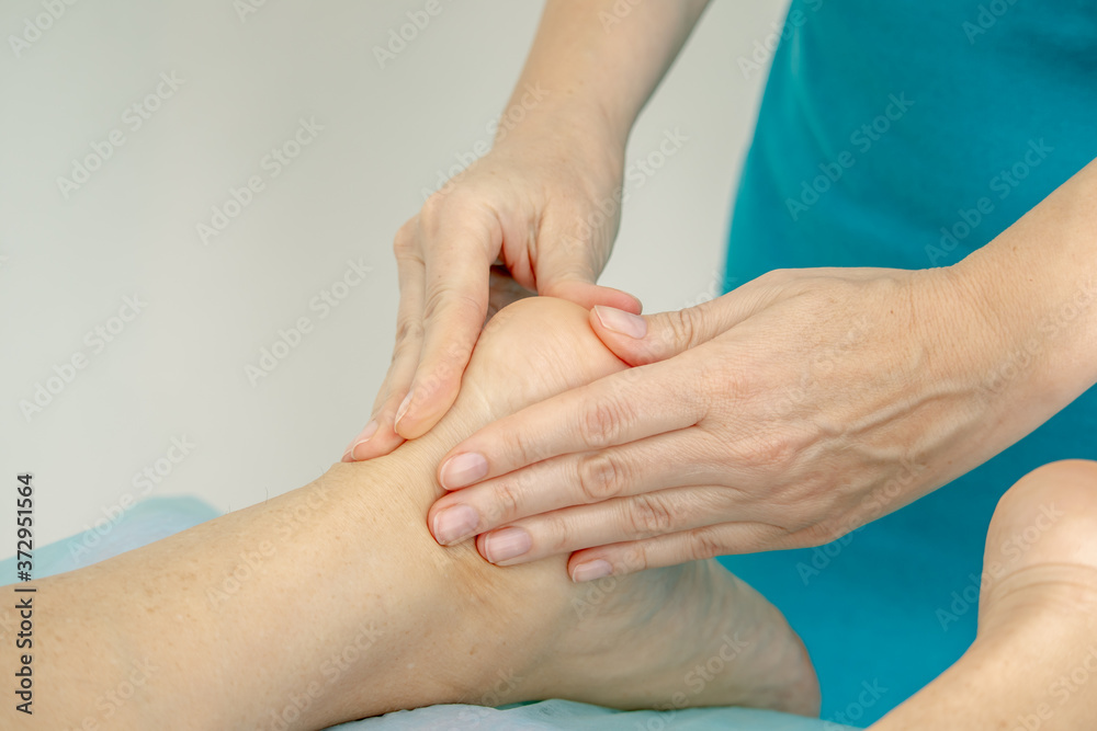 Foot foot massage hands in the Spa close up Foot foot massage hands in the Spa close up