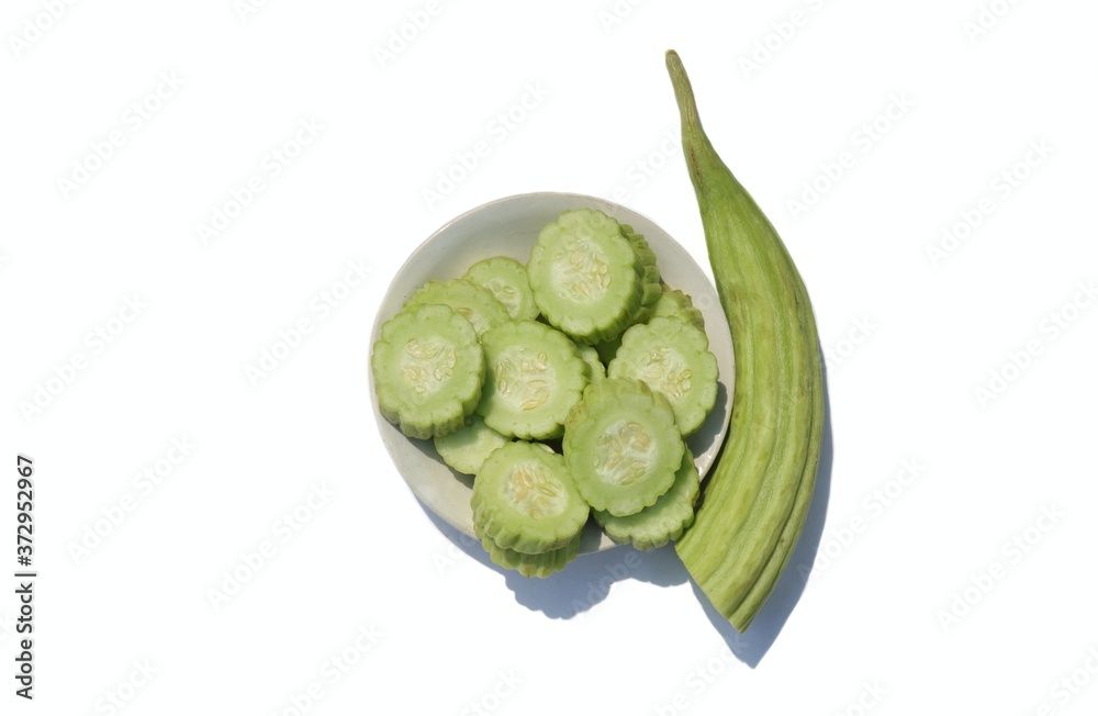 Armenian Cucumber or Yard Long Cucumber in a Plate Isolated on White Background with Copy Space, Also Known as Kakri Armenian Cucumber or Yard Long Cucumber in a Plate Isolated on White Background with Copy Space, Also Known as Kakri