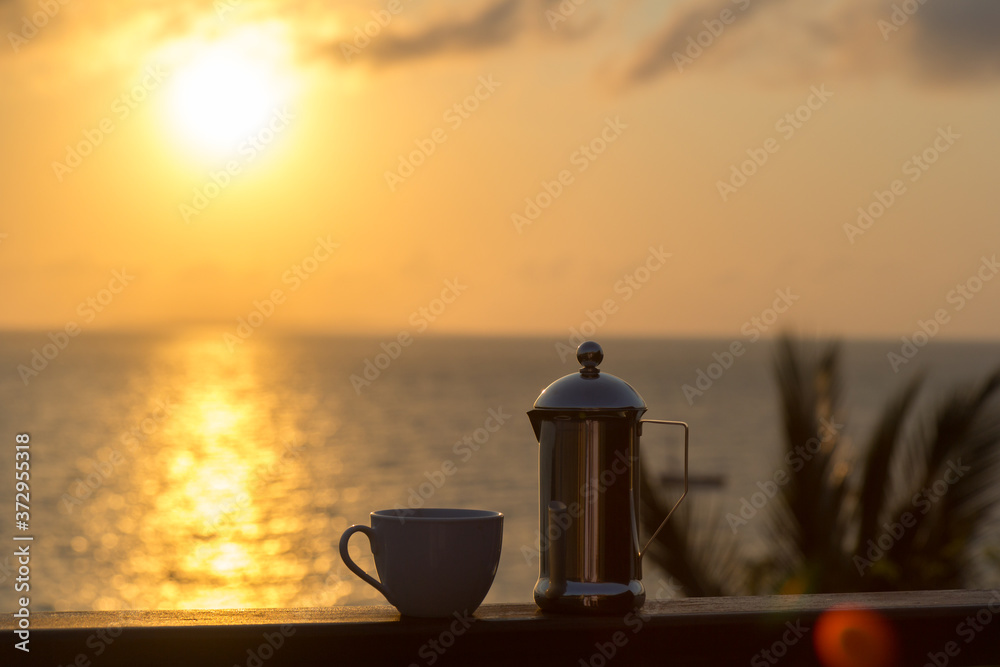 mug and pot at tropical sunrise