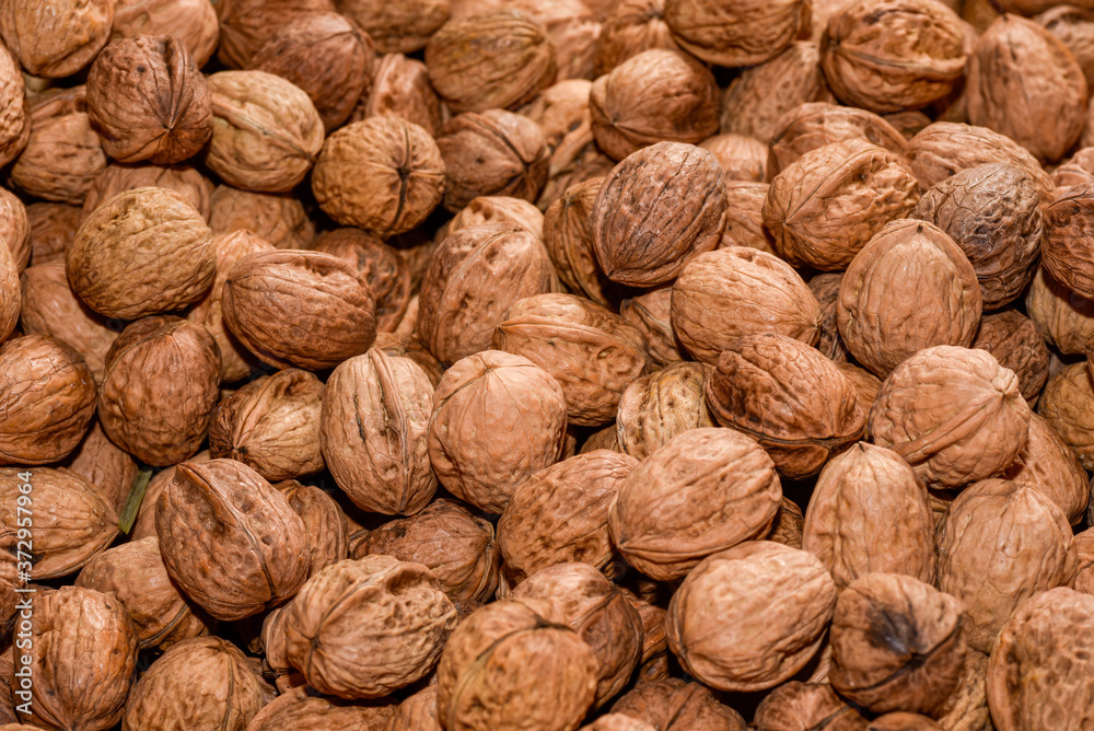 Full frame of natural walnuts as backdrop Full frame of natural walnuts as backdrop