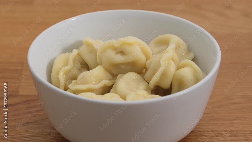 Bowl of homemade boiled dumplings close up