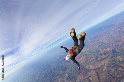 skydiver man in freefall diving at sunny day