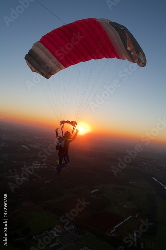 skydiver flying alone at the sunset, adventure concept