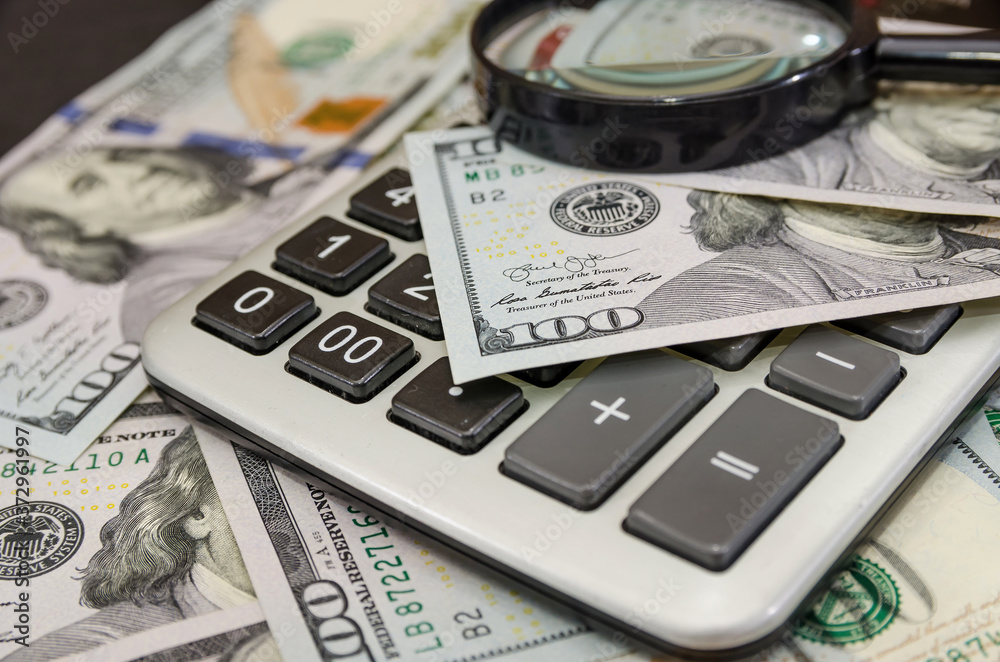 Dollars, calculator and magnifier. Financial concept. Dollars, calculator and magnifier. Financial concept.