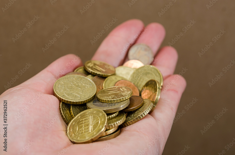 Euro cents in a woman's hand. Close-up. Coins in hand. Financial concept. Euro cents in a woman's hand. Close-up. Coins in hand. Financial concept.