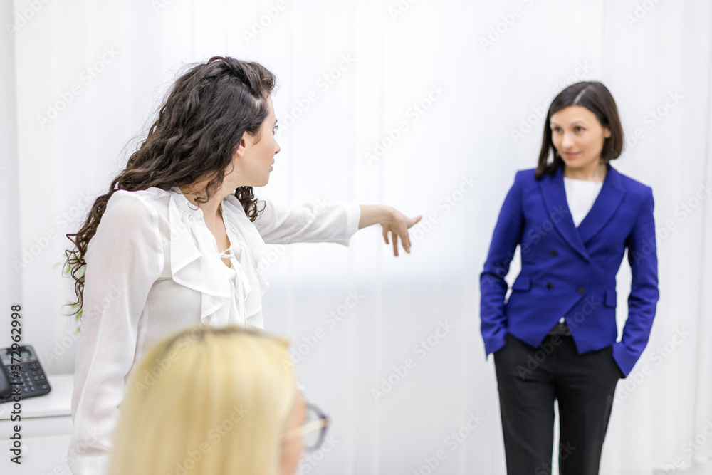 Photo of two women having some trouble working together. Photo of two women having some trouble working together.