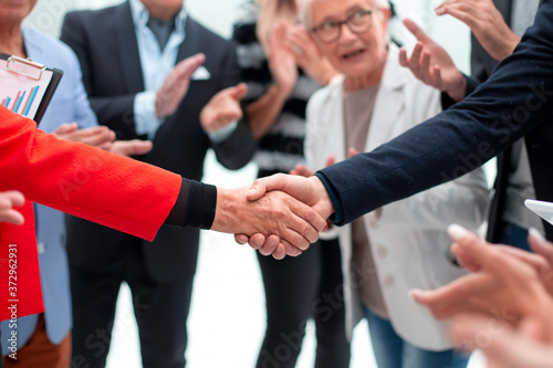 colleagues handshaking after meeting in office © ASDF