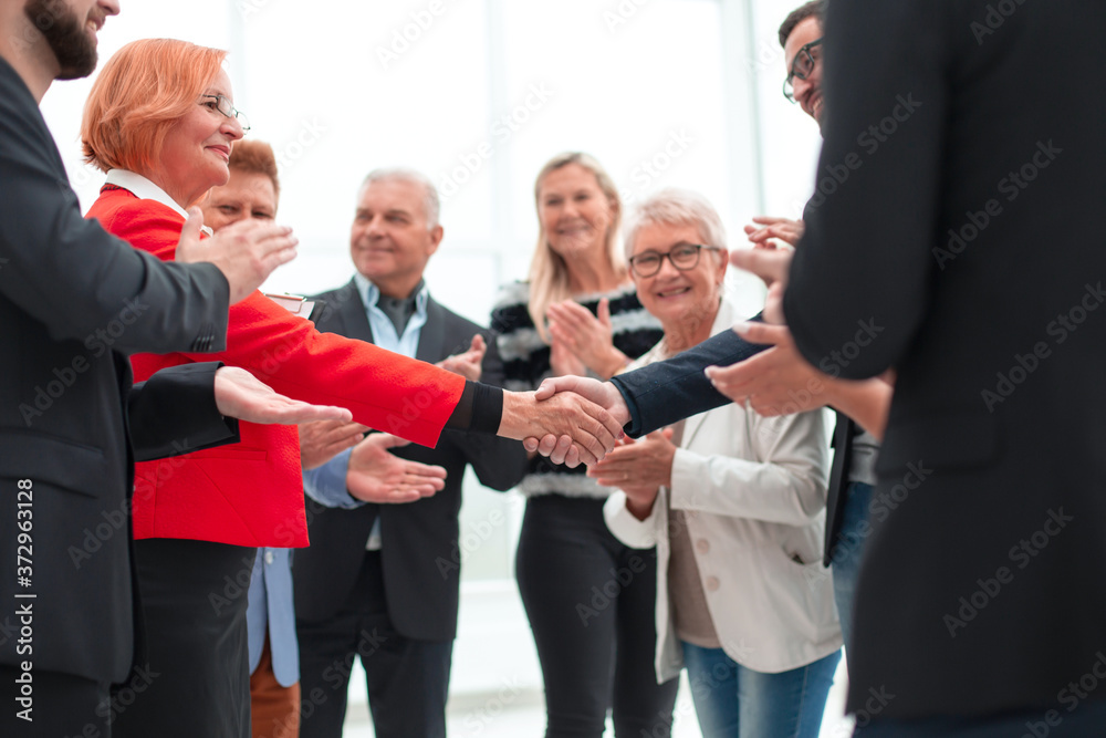 colleagues handshaking after meeting in office colleagues handshaking after meeting in office