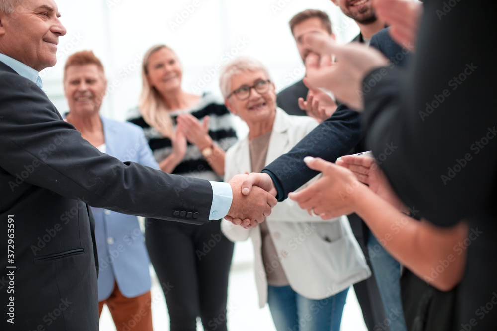 colleagues handshaking after meeting in office colleagues handshaking after meeting in office