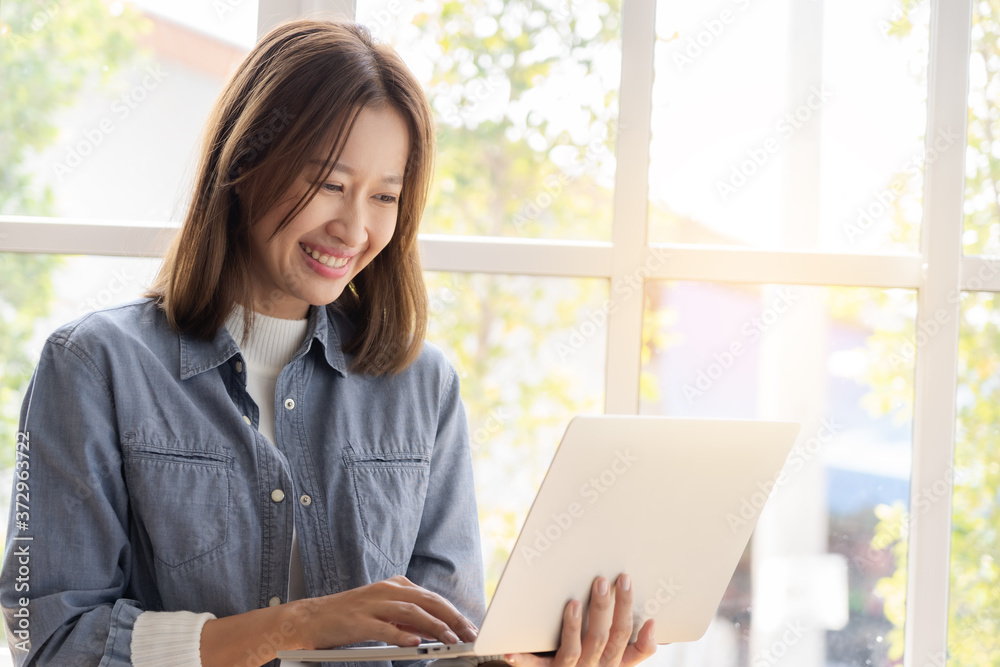 Asian woman winner watching laptop Asian woman winner watching laptop