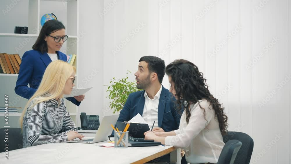 4k video of colleagues employees cooperating in office talking working together at workplace. 4k video of colleagues employees cooperating in office talking working together at workplace.