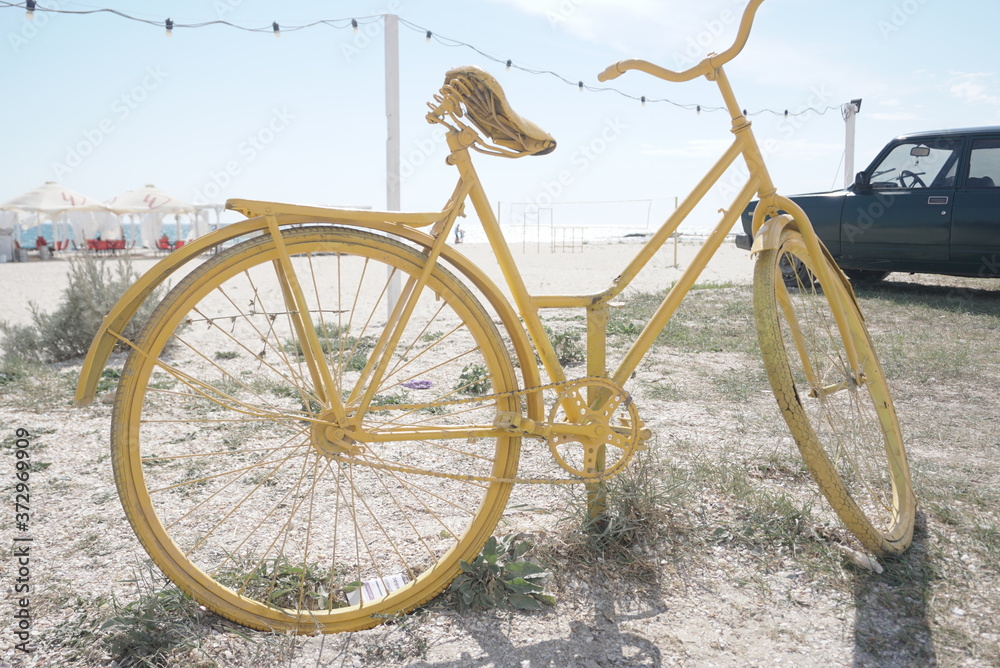 Fototapeta premium old bicycle painted in yellow for decoration
