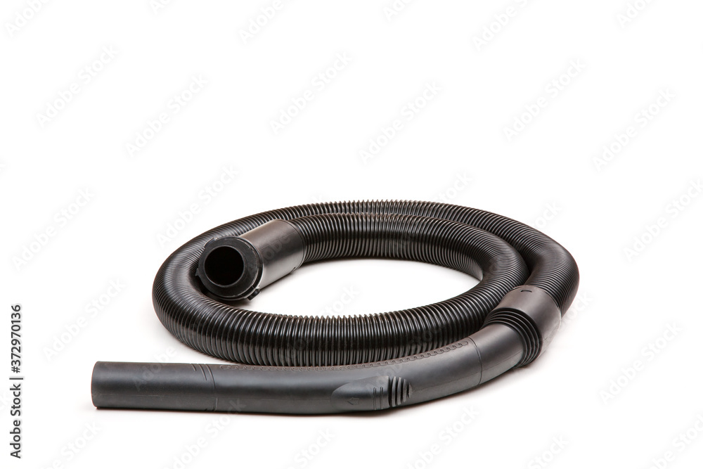 Obraz premium Black hose of the vacuum cleaner isolated on a white background . There is some free space for your text or sign.