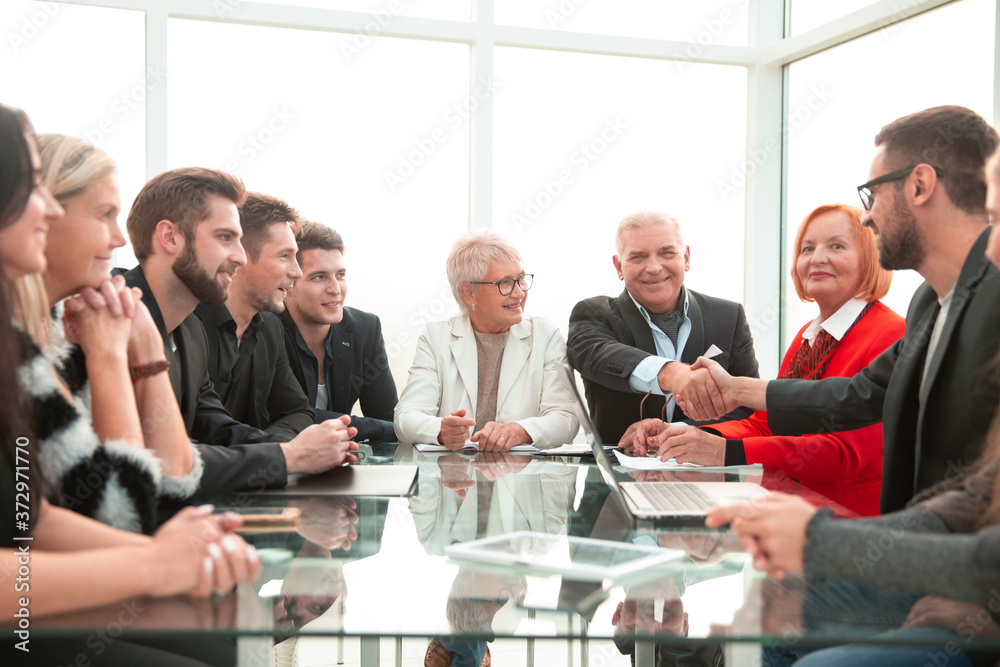businessmen shaking hands in a meeting at office businessmen shaking hands in a meeting at office